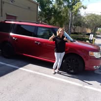 Happy customer with freshly detailed red Ford Flex